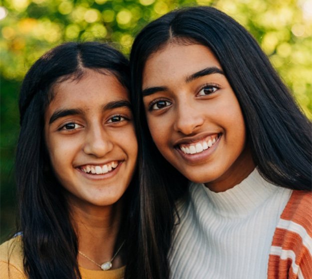 Woman and daughter turning in dental insurance forms