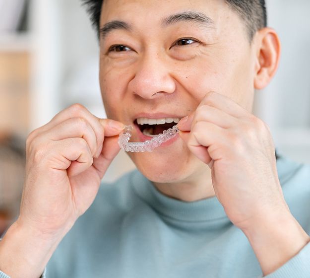 Woman holding Invisalign on white background