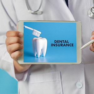 Medical professional holding tablet with dental insurance information