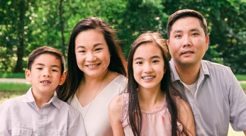 Two young patients and their parents smiling