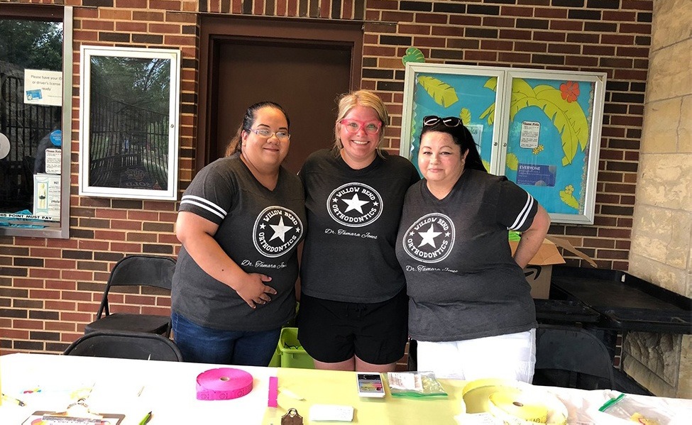 Three team members at community event