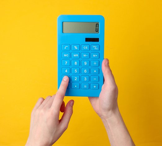 Hands holding blue calculator against yellow background