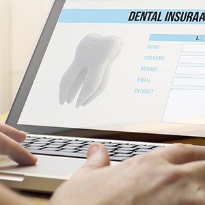 Dental insurance information displayed on laptop