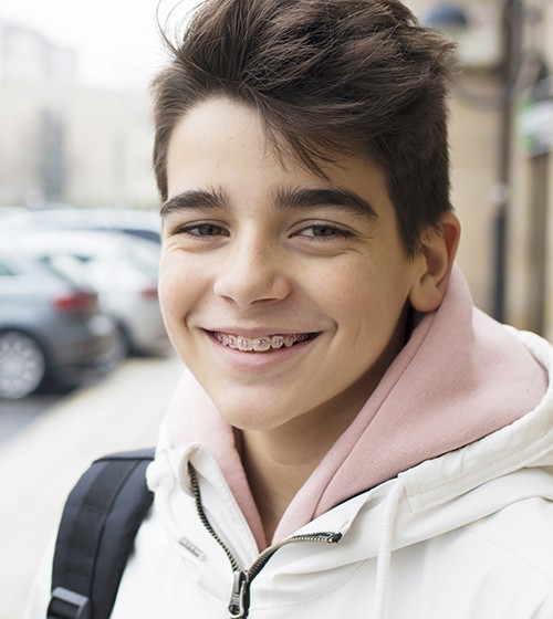 Smiling teen boy receiving dentofacial orthopedic treatment