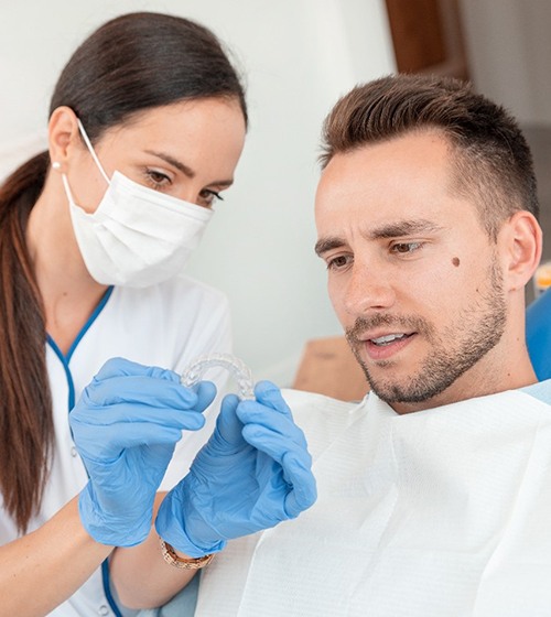 Orthodontist in Plano showing patient Invisalign aligner