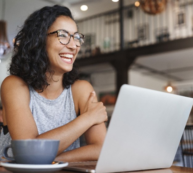 Woman smiling while working at coffee shop