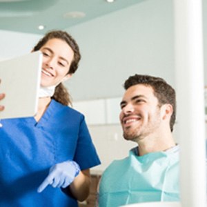 Man smiling while Plano orthodontist explains orthodontic treatment