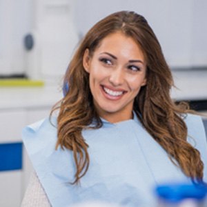 Woman with beautiful, straight teeth smiling in treatment chair