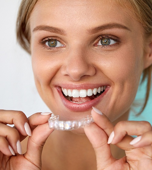 Woman placing an Invisalign tray