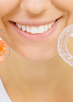 A woman holding two retainers