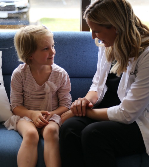 Doctor Jones talking to young orthodontic patient