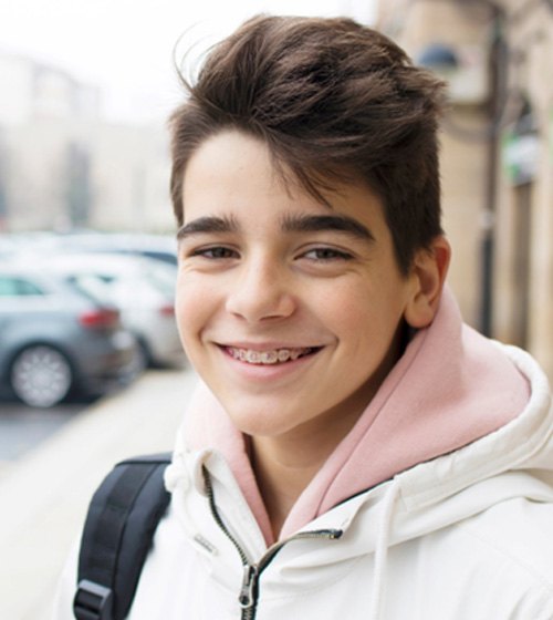 young boy with braces smiling