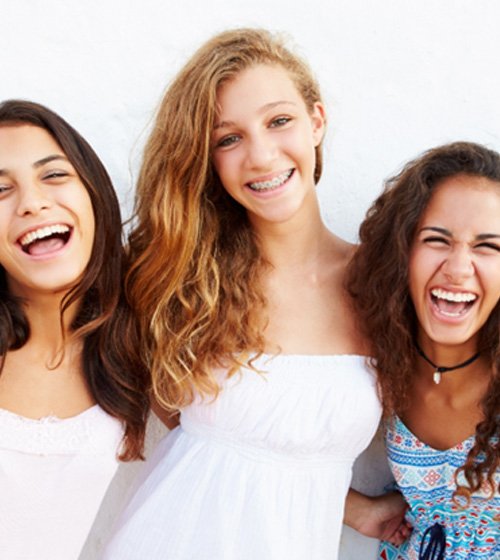 young girls smiling together 