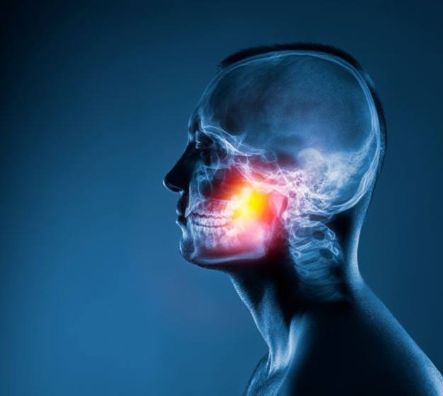 TMJ highlighted on illustration of human anatomy