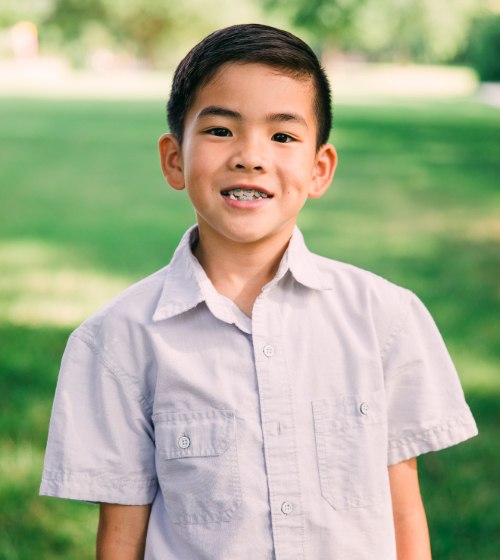 Smiling young boy with traditional braces