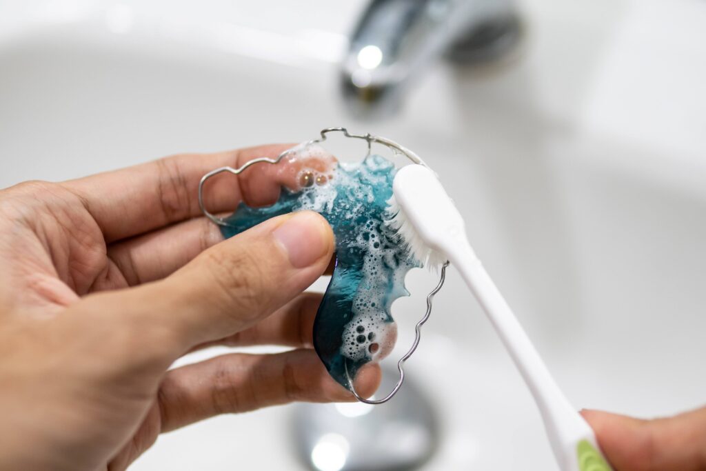 Closeup of patient cleaning retainer
