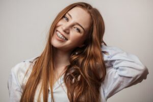 Woman smiling after adjusting to her braces