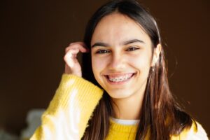 Teenage girl with braces smiling.